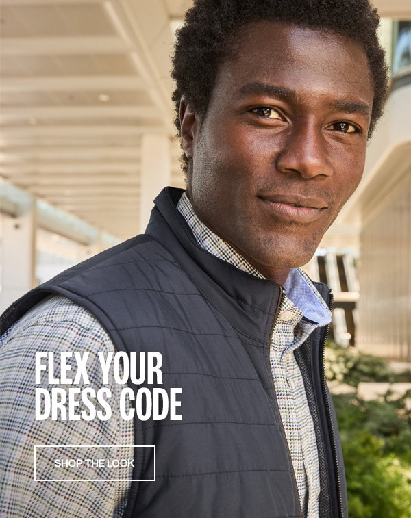 Model wearing a navy quilted vest over a plaid shirt. Text reads: 