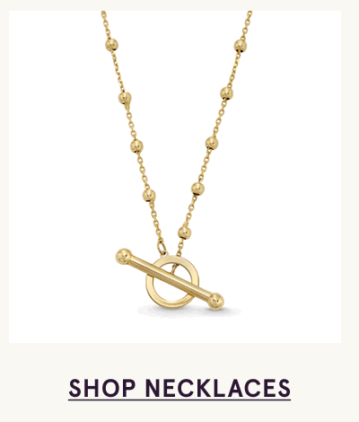 Gold beaded chain with front-facing toggle clasp pendant. Click here to shop necklaces