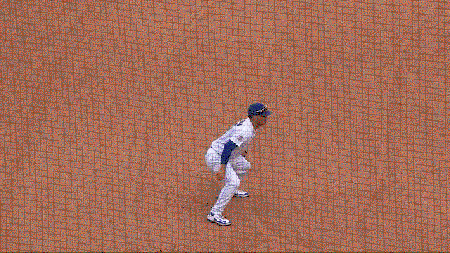 An animated gif of Alex Bregman making a diving stop and throw 