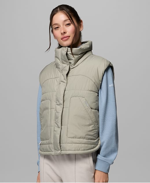 A woman wearing a light green vest