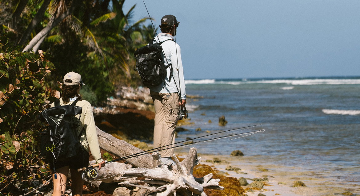 Two anglers on a beach with fishing gear