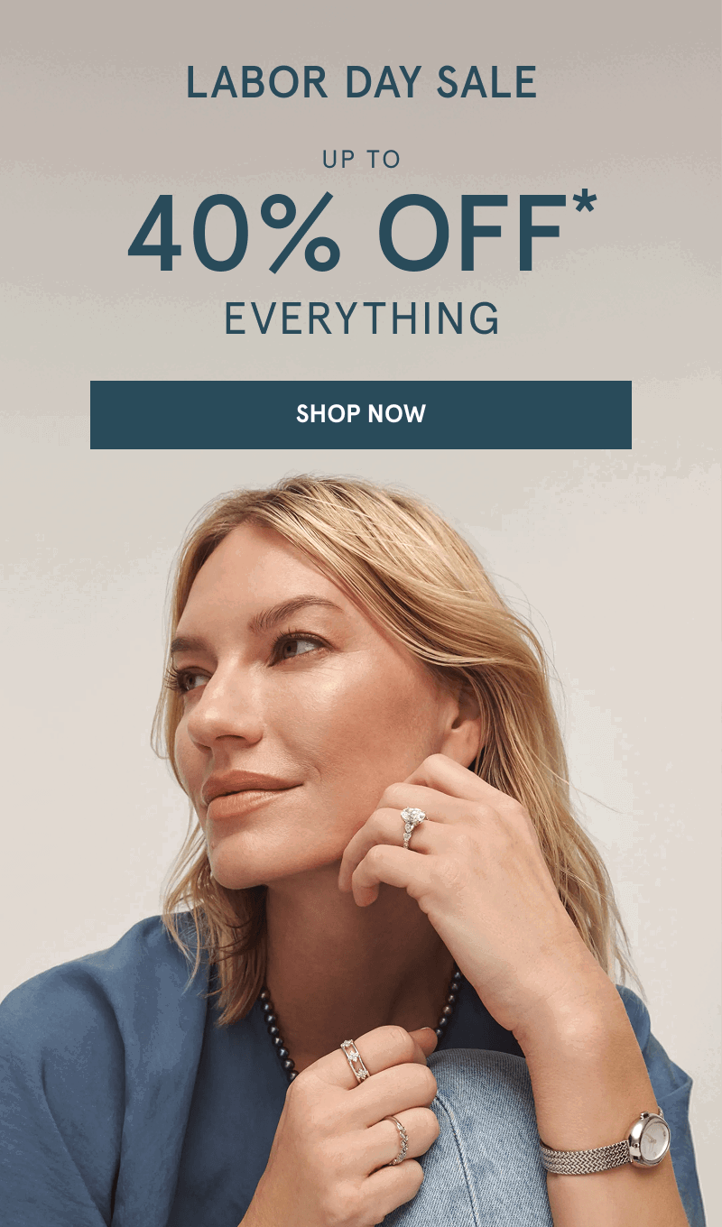 Woman wearing diamond rings, pearl necklace and silver-tone mesh watch. Labor Day sale. Click shop now.