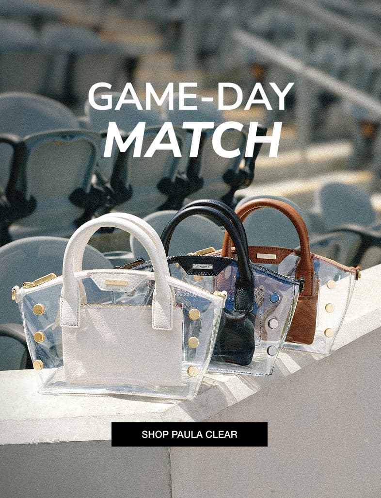 GAME-DAY MATCH. Three Paula Clear bags with Calla Lily White, Black, and Mahogany Pebble leather accents displayed on stadium seats. SHOP PAULA CLEAR.