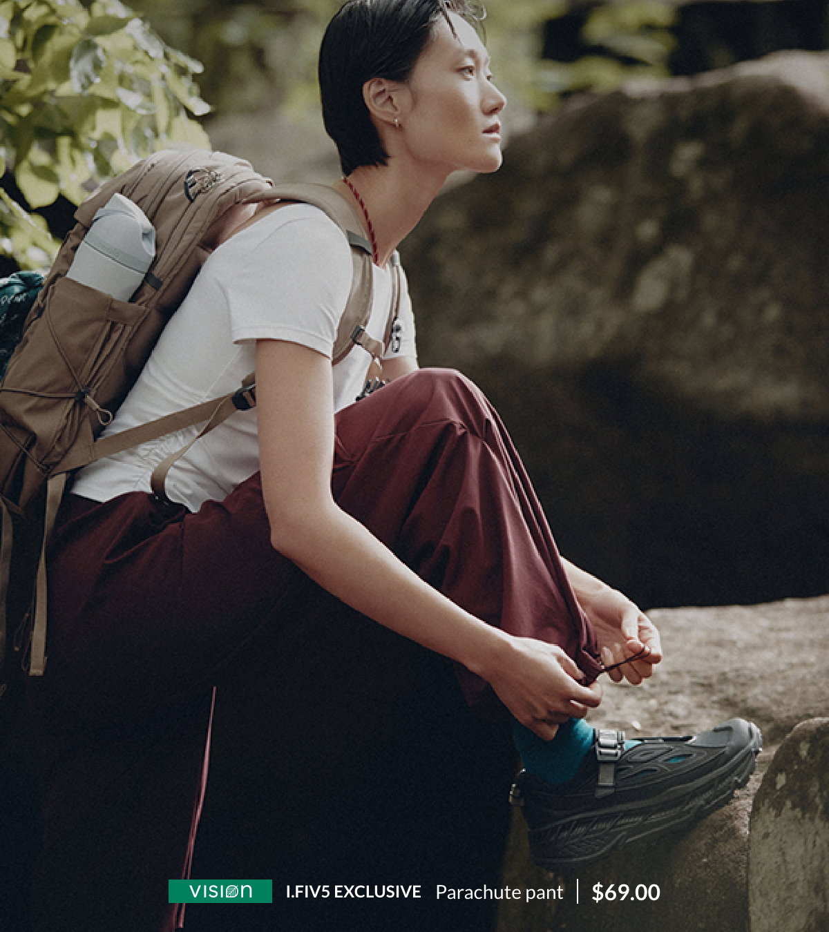 A woman is in nature wearing a burgundy stretch weave parachute pant, Simons exclusive, at $69.00