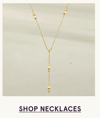 A delicate gold lariat necklace. Click here to shop necklaces