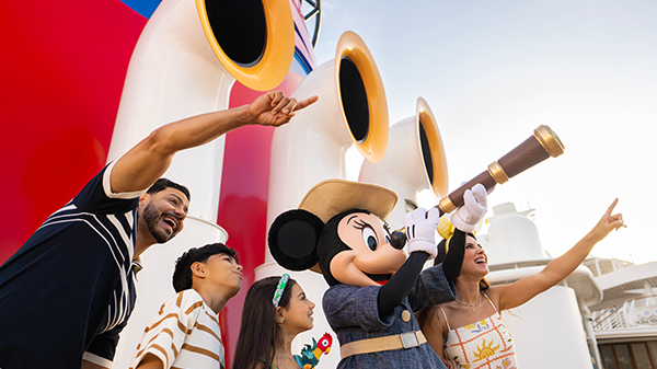 A family points off into the distance alongside Voyager Minnie looking through a spyglass.