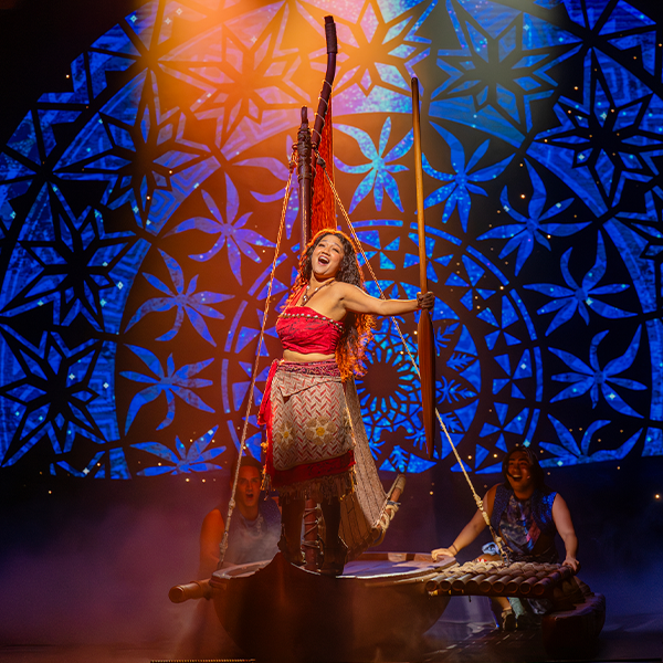 A performer dressed as Moana delivers a powerful moment atop her canoe in the Broadway-style production inspired by the film.