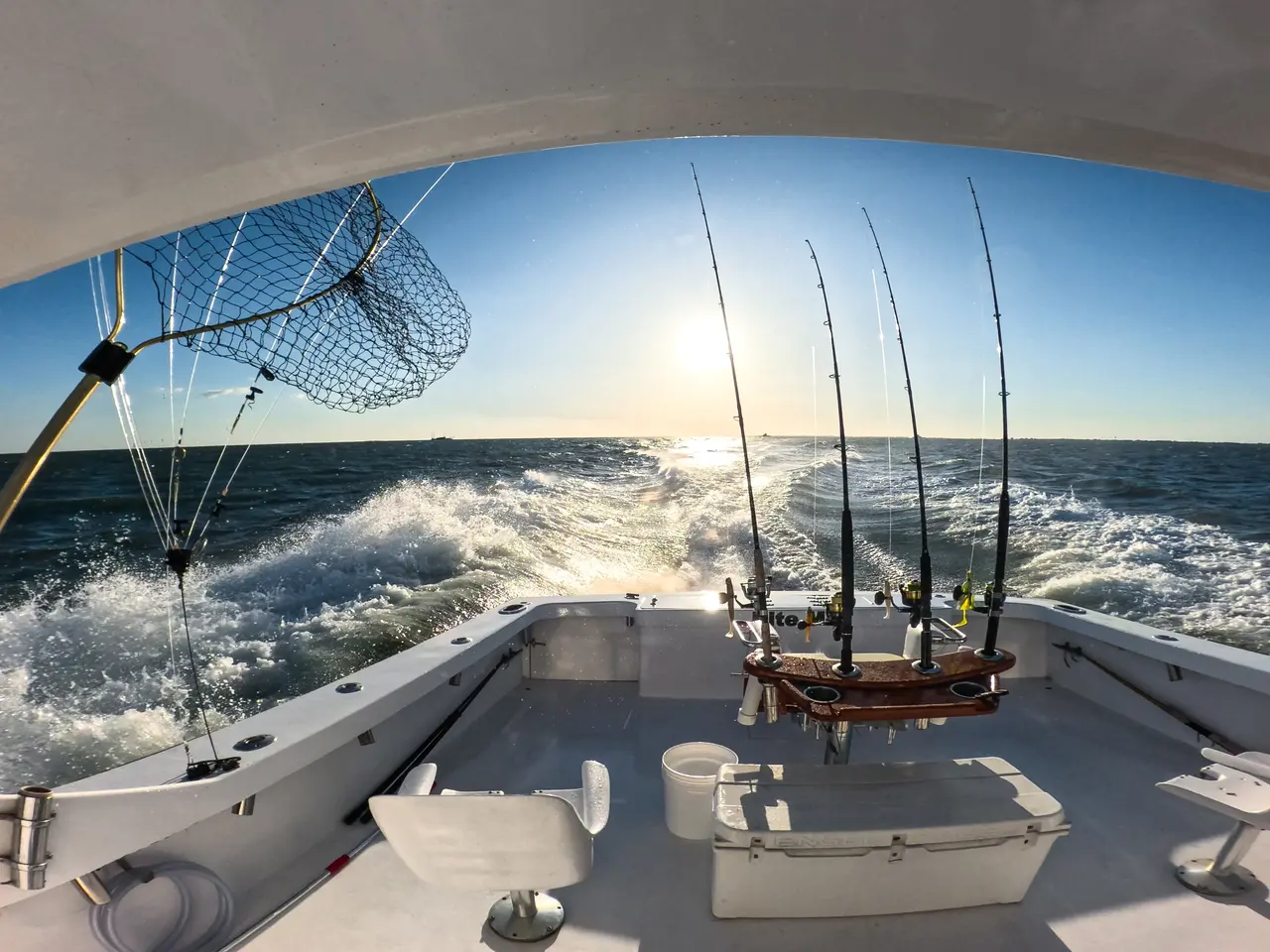 Wide-angle view of fishing boat deck at sunset.