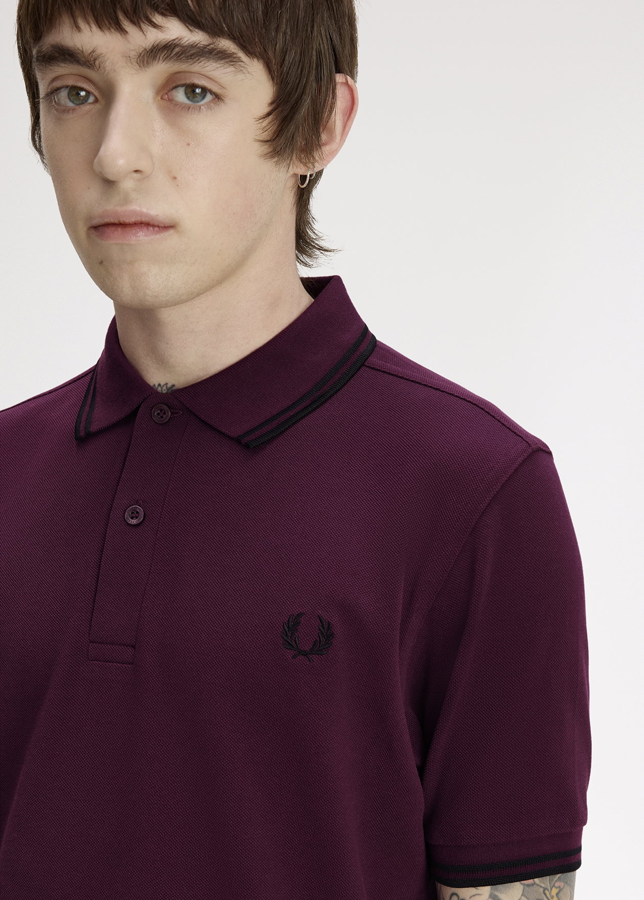 Male model wearing a M3600 Twin Tipped Fred Perry Shirt in Plum / Black / Black