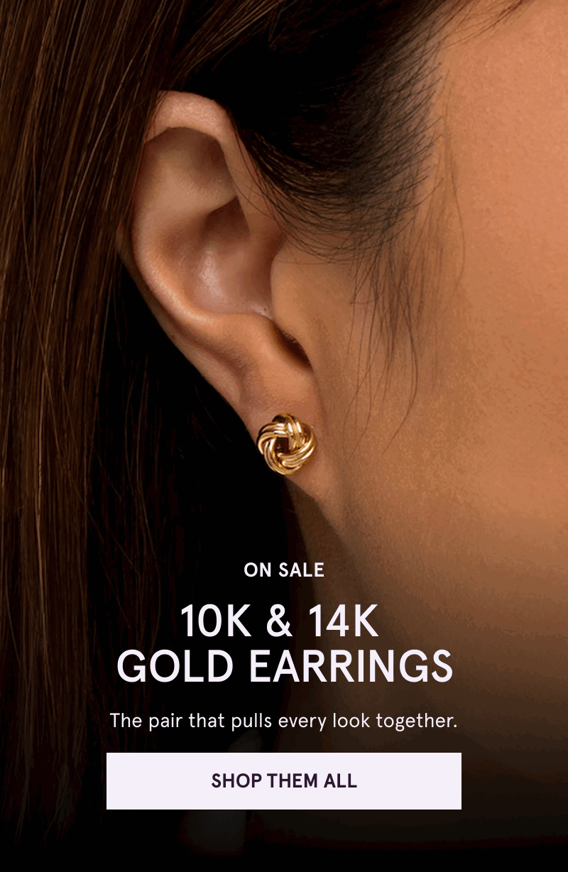 Close-up of gold love-knot stud on ear.  On sale 10K & 14K gold earrings. Click here to shop them all 