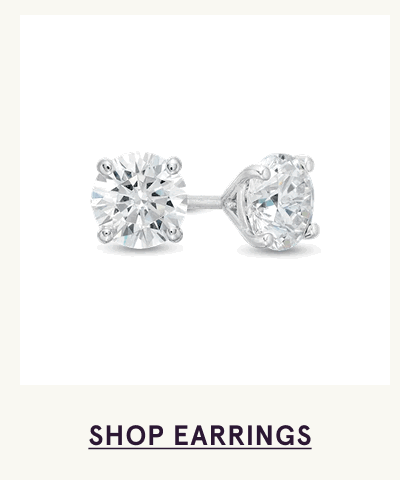 Pair of classic round-cut diamond studs set in white metal. Click here to shop earrings