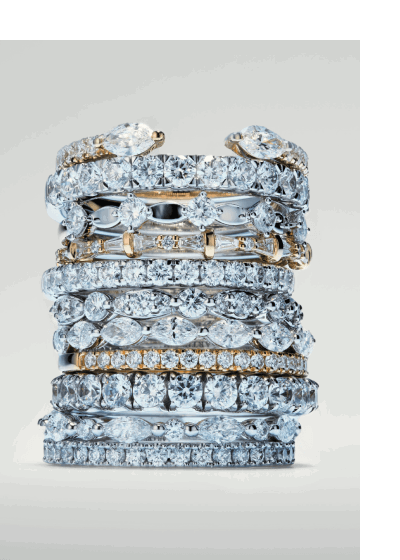 Stack of diamond wedding bands in mixed metals featuring pavé and channel-set diamonds.