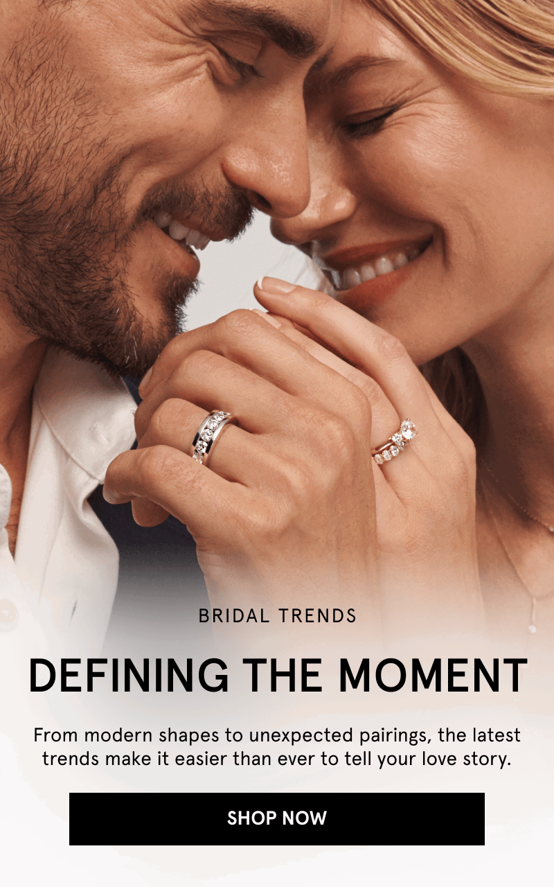 Close-up of a couple wearing diamond wedding rings. Bridal trends defining the moment. Click shop now.