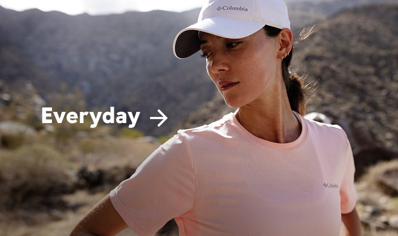 A woman standing in a rocky landscape with text: Everyday
