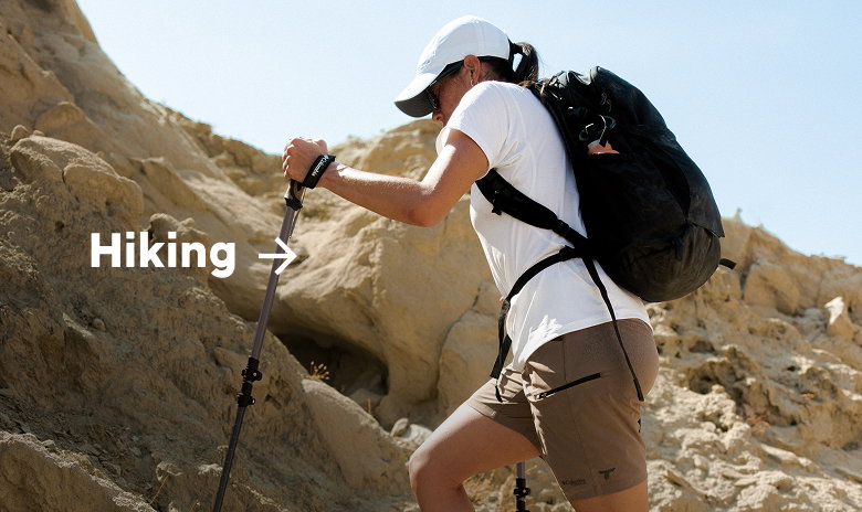 A woman hiking in a rocky landscape with text: Hiking