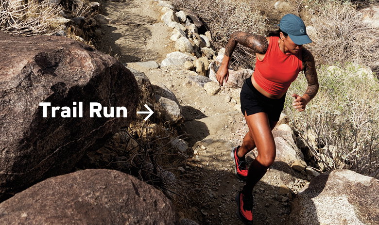 A woman running in the desert with text: Trail Run
