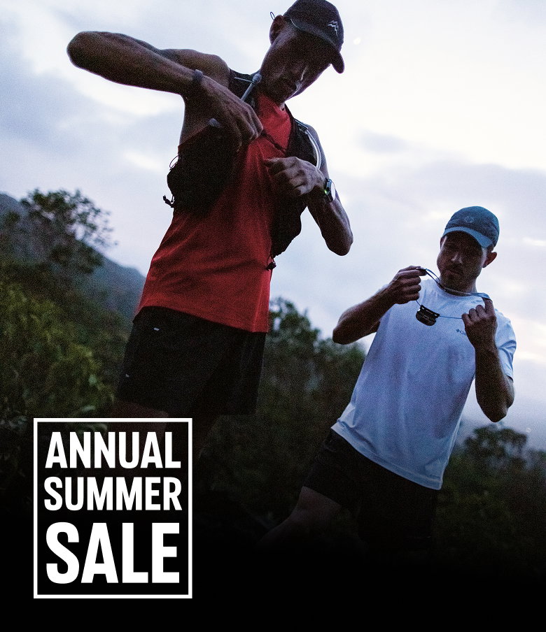 Two runners putting on gear in the morning with text: ANNUAL SUMMER SALE