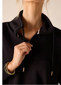 Close up image of a black French terry quarter zip sweatshirt
