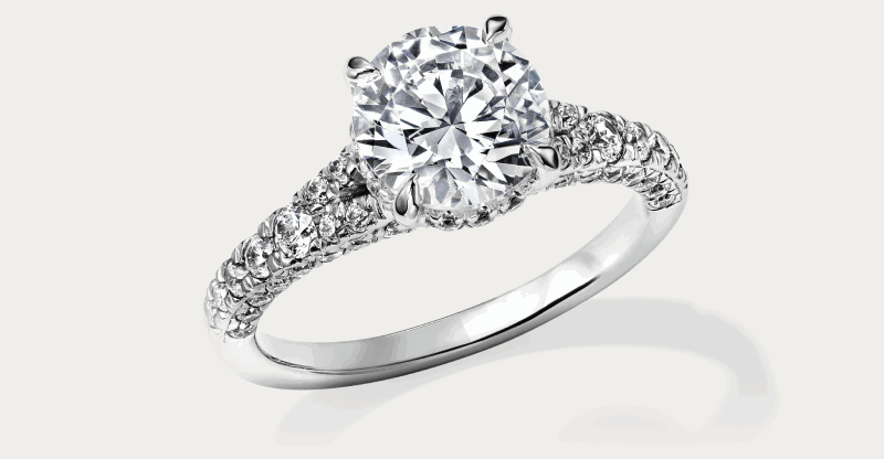 Round-cut diamond engagement ring in white gold with a diamond-set band.