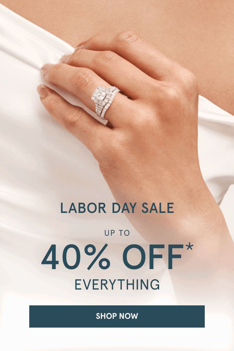 Hand wearing a diamond engagement ring. Labor day sale. Up to 40% off everything. Click shop now.