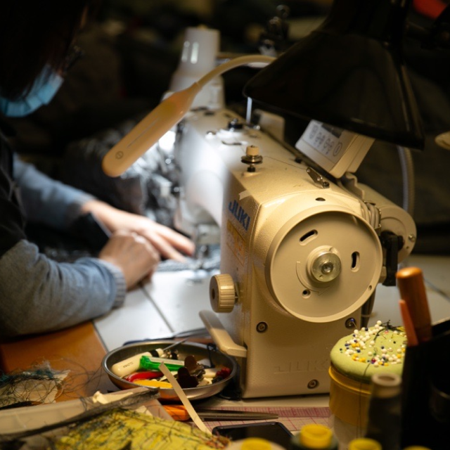 Up-close shot of someone on the warranty team sewing.