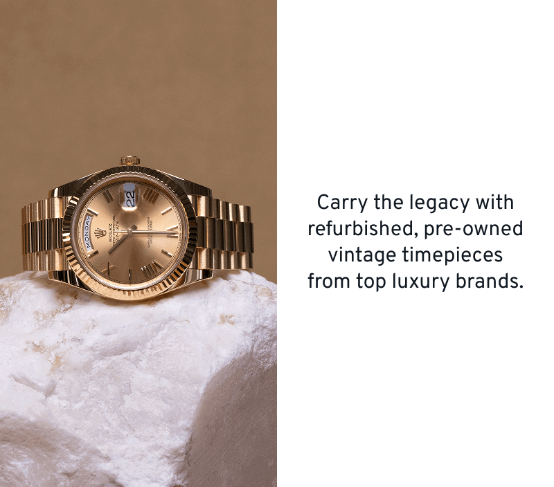 Vintage gold luxury watch on stone.  Refurbished, pre-owned luxury timepieces. 