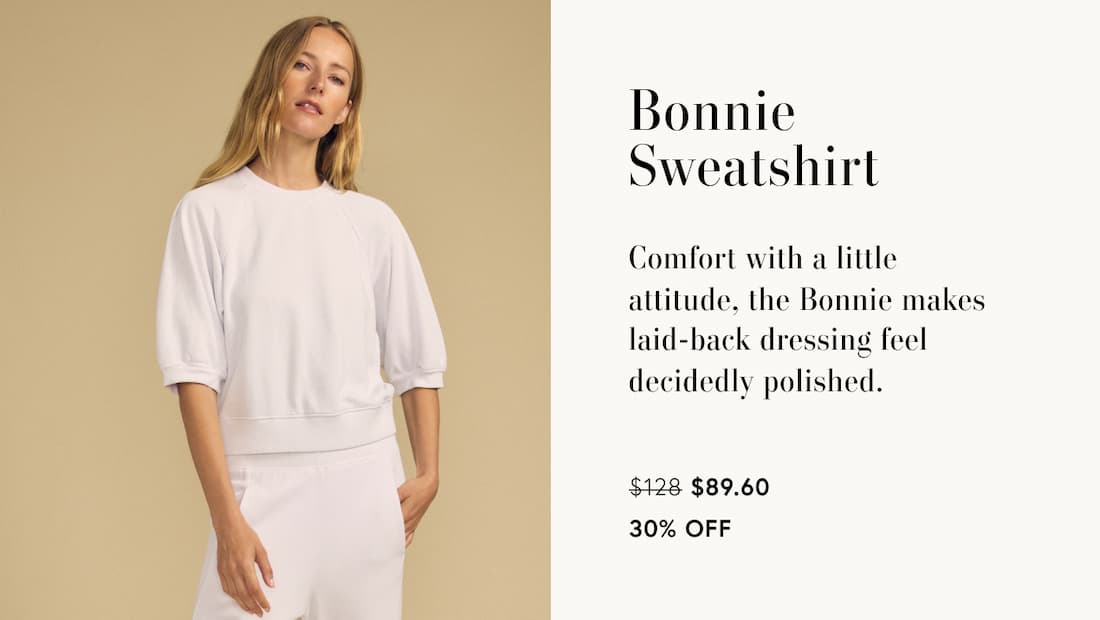 Image of model wearing Bonnie in Feather Grey. Text Reads: Bonnie Sweatshirt. Comfort with a little attitude, the Bonnie makes laid-back dressing feel decidedly polished.