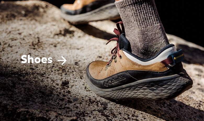 Close-up of someone's brown hiking shoe with text: Shoes
