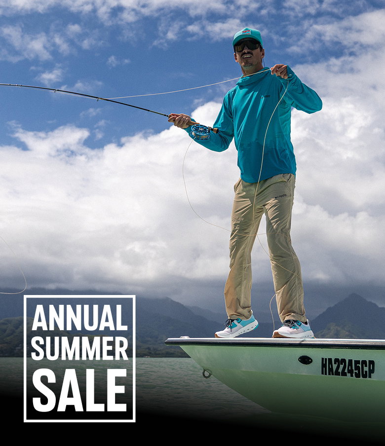 A man standing on a skiff with a fishing rod in hand with text: ANNUAL SUMMER SALE