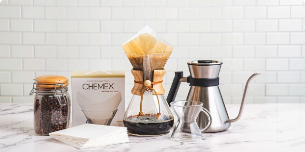 Chemex pour-over coffee setup with fresh beans and brewing accessories