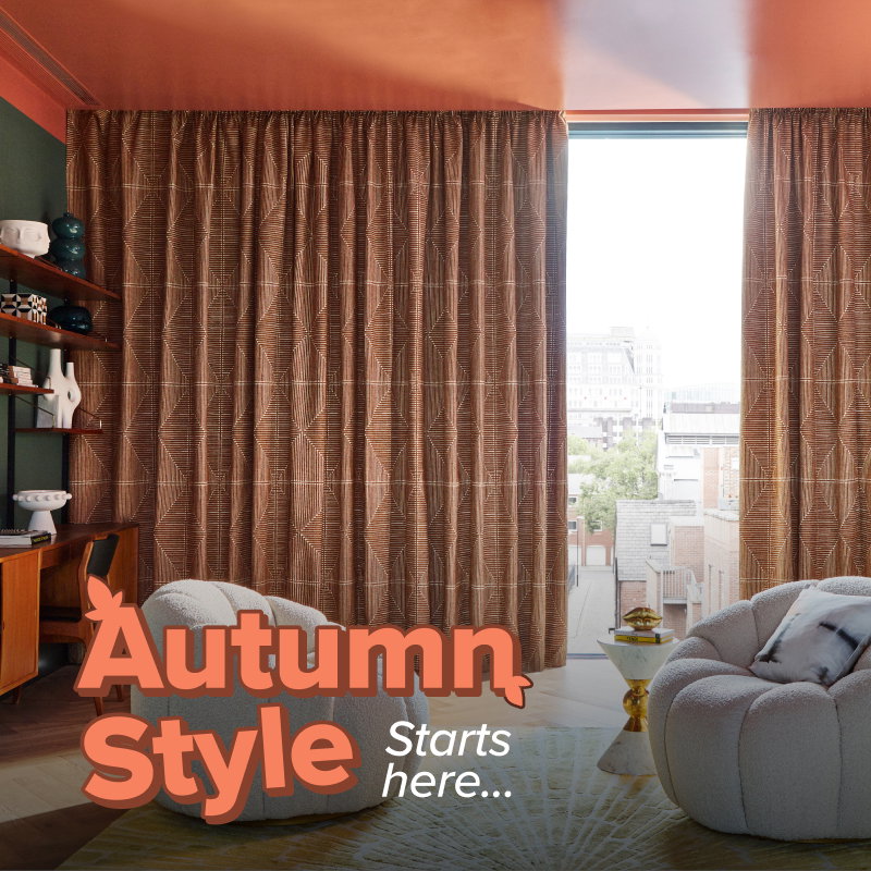Geometric brown curtains frame a tall window, bringing warmth and texture to a contemporary living space with statement armchairs.