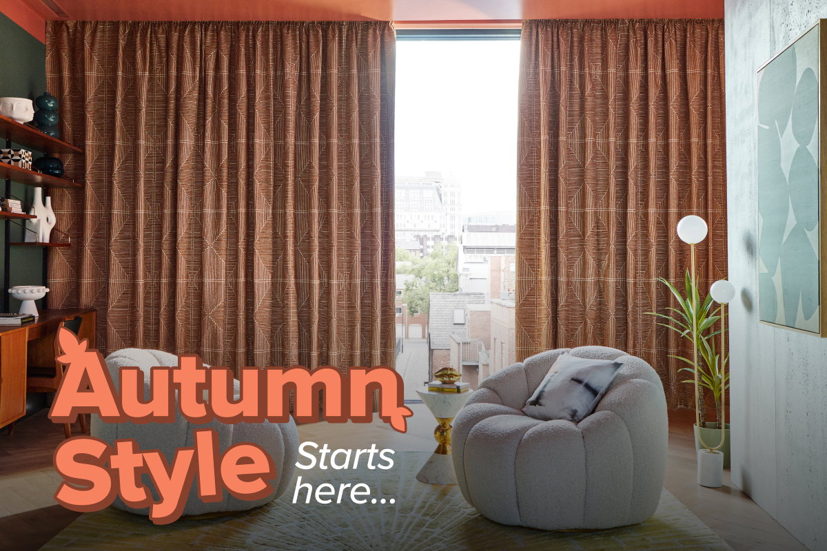 Geometric brown curtains frame a tall window, bringing warmth and texture to a contemporary living space with statement armchairs.