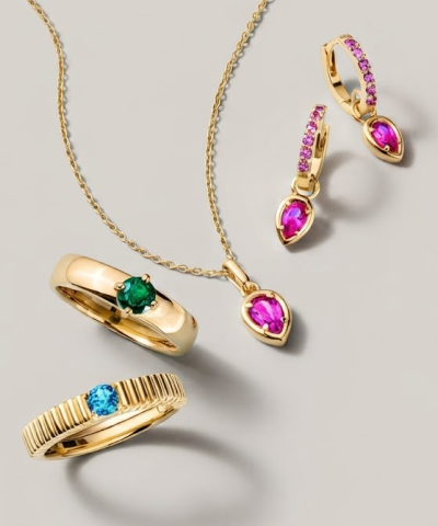 Gold necklace, earrings and rings featuring pink, green and blue gemstones.