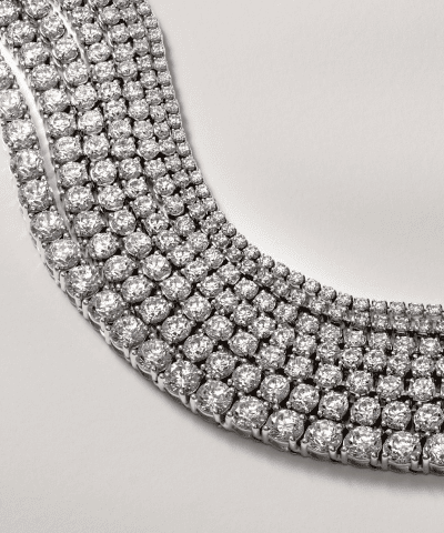 Multi-row diamond tennis necklace in white gold featuring round brilliant-cut diamonds.