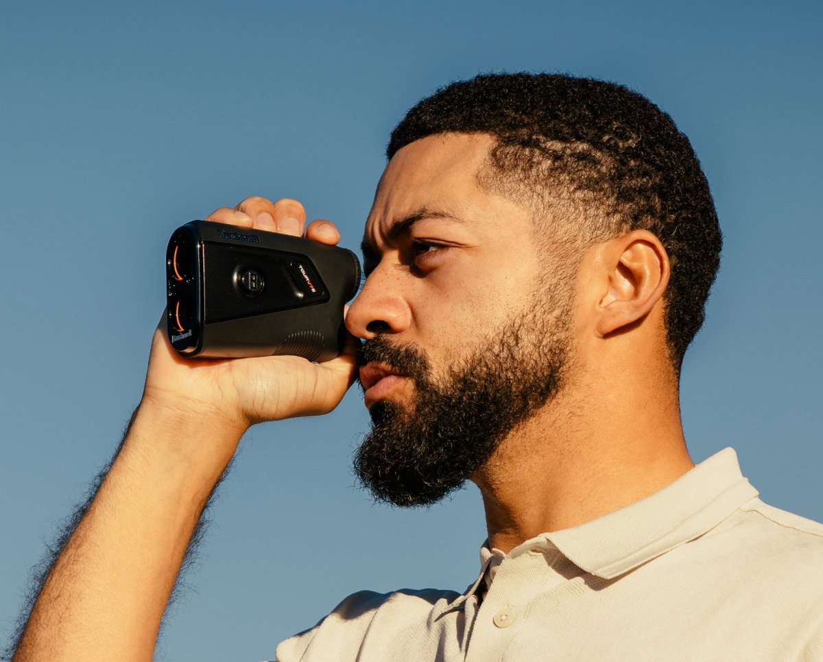 Image of a man using a Bushnell Range Finder