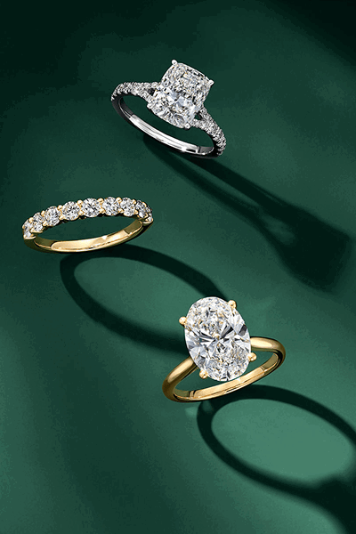 Two diamond engagement rings and one diamond band.