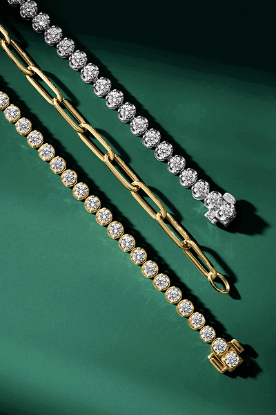 Two diamond tennis necklaces and one chain necklace.
