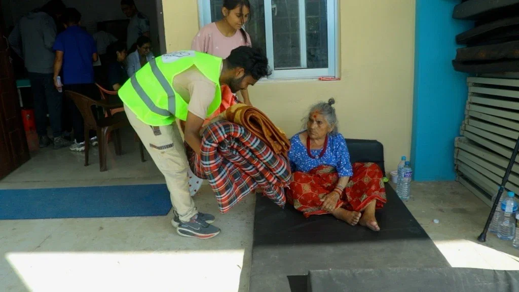 Rescue team carrying stretcher through flood debris