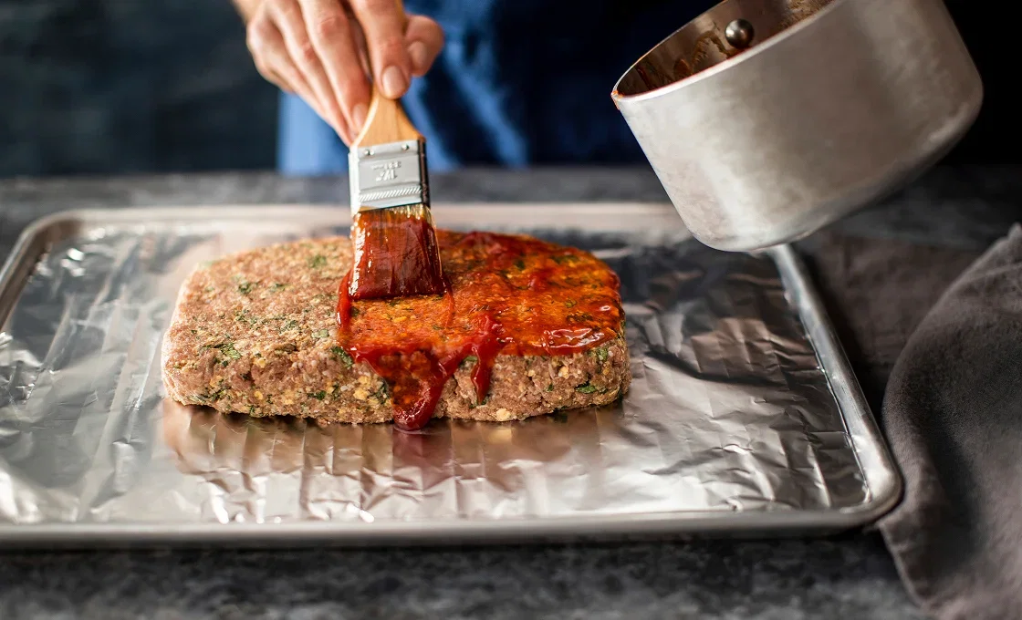 Applying glaze to the meatloaf