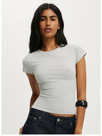 Woman wearing light gray fitted t-shirt and dark jeans