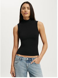 Woman wearing black sleeveless turtleneck and light blue jeans