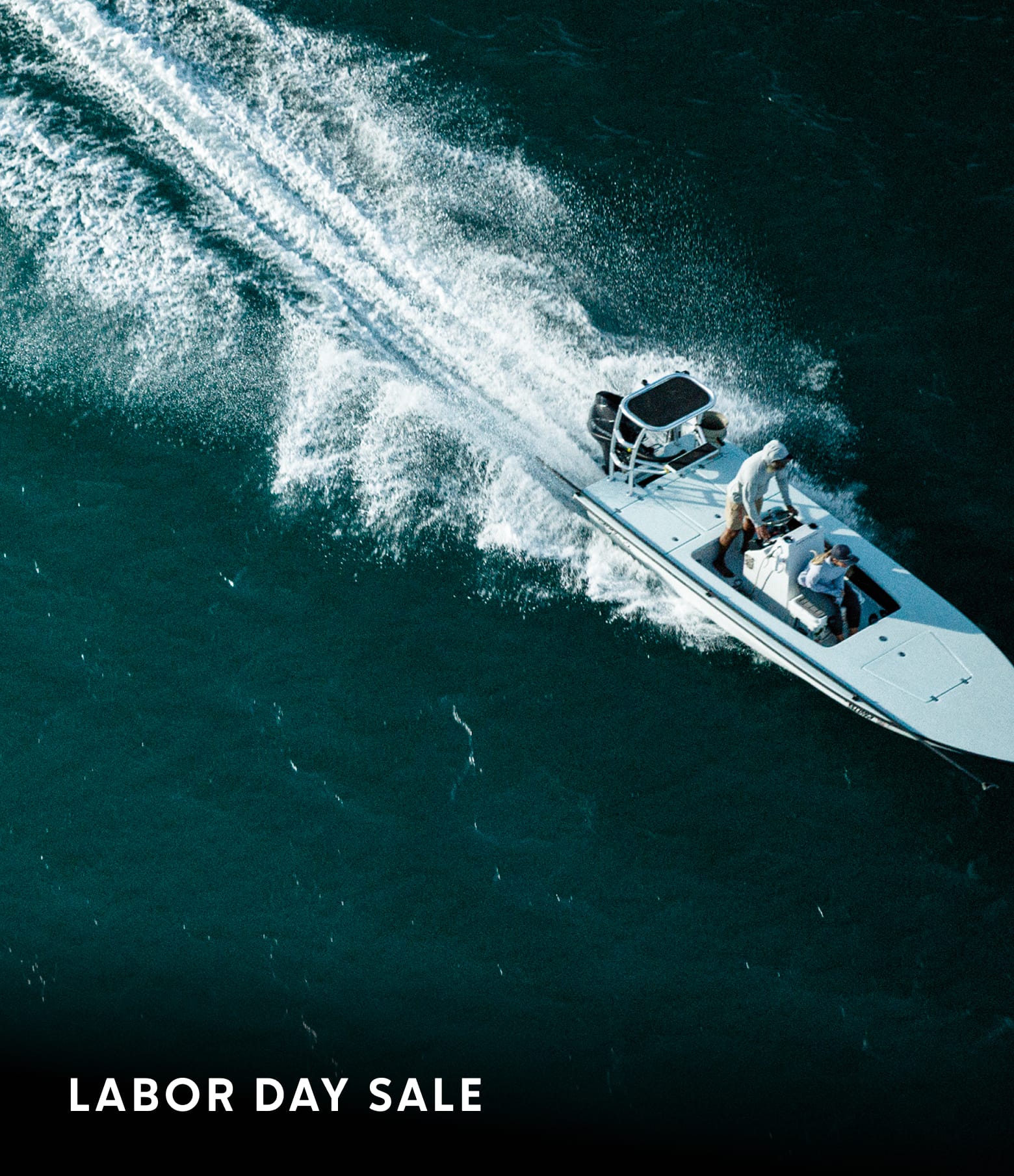 Aerial shot of a two anglers on a boat in the water with text: ANNUAL SUMMER SALE