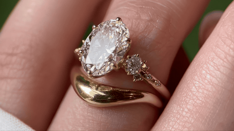 Overview of the new Resonate Ring with 3.5ct oval cut shown paired with the Amplify Band worn by a model.