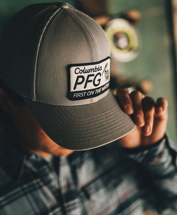 Close-up of a man's gray ball cap with a Columbia PFG patch on the front.