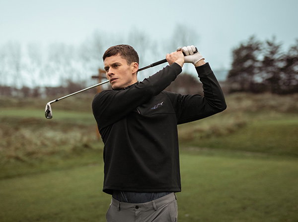 Golfer taking golf swing with an Iron
