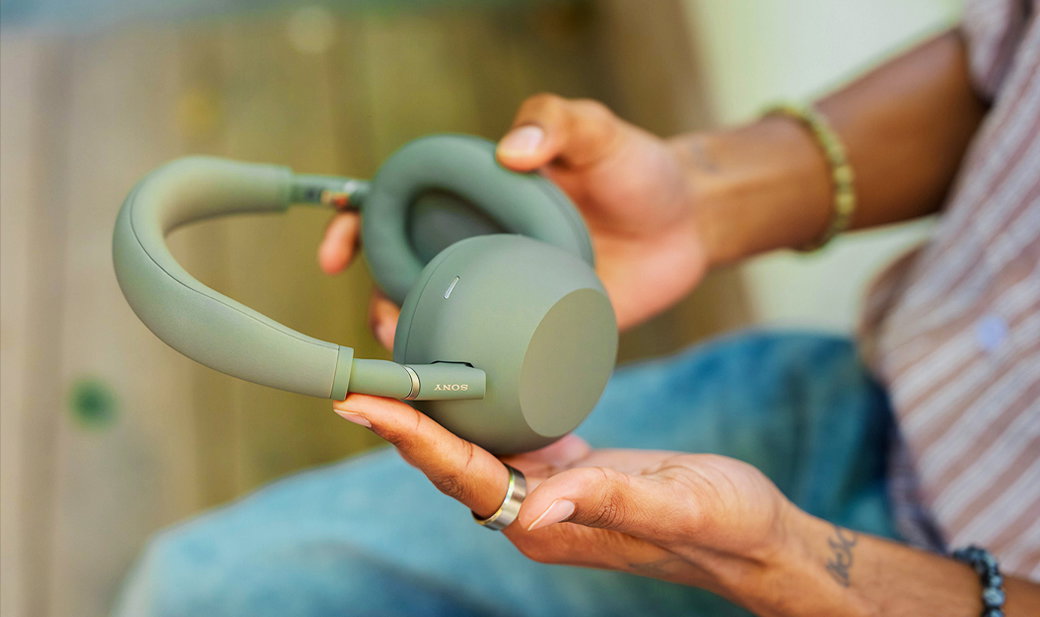 An image of woman's hands holding a pair of WH-1000XM6 Best Wireless Noise Cancelling Headphones | Olive Gray