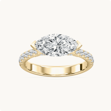 Marquise Lab Grown Diamond 2 1/2ctw. East West Half Bezel Engagement Ring in 14k Yellow Gold: Oval-cut diamond engagement ring with a pavé diamond band, set in yellow gold.