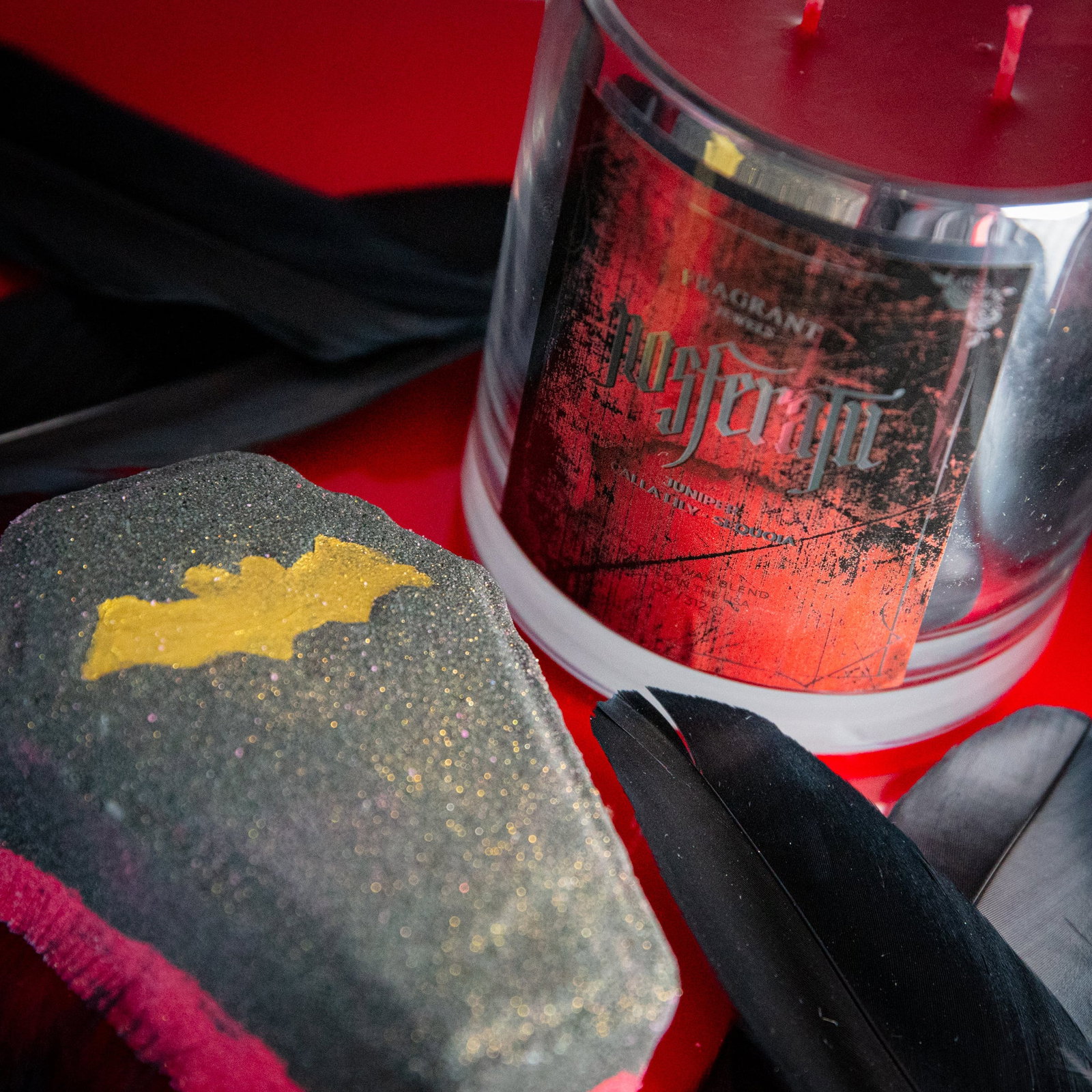 Nosferatu Inner Circle candle and bath bomb on crimson velvet