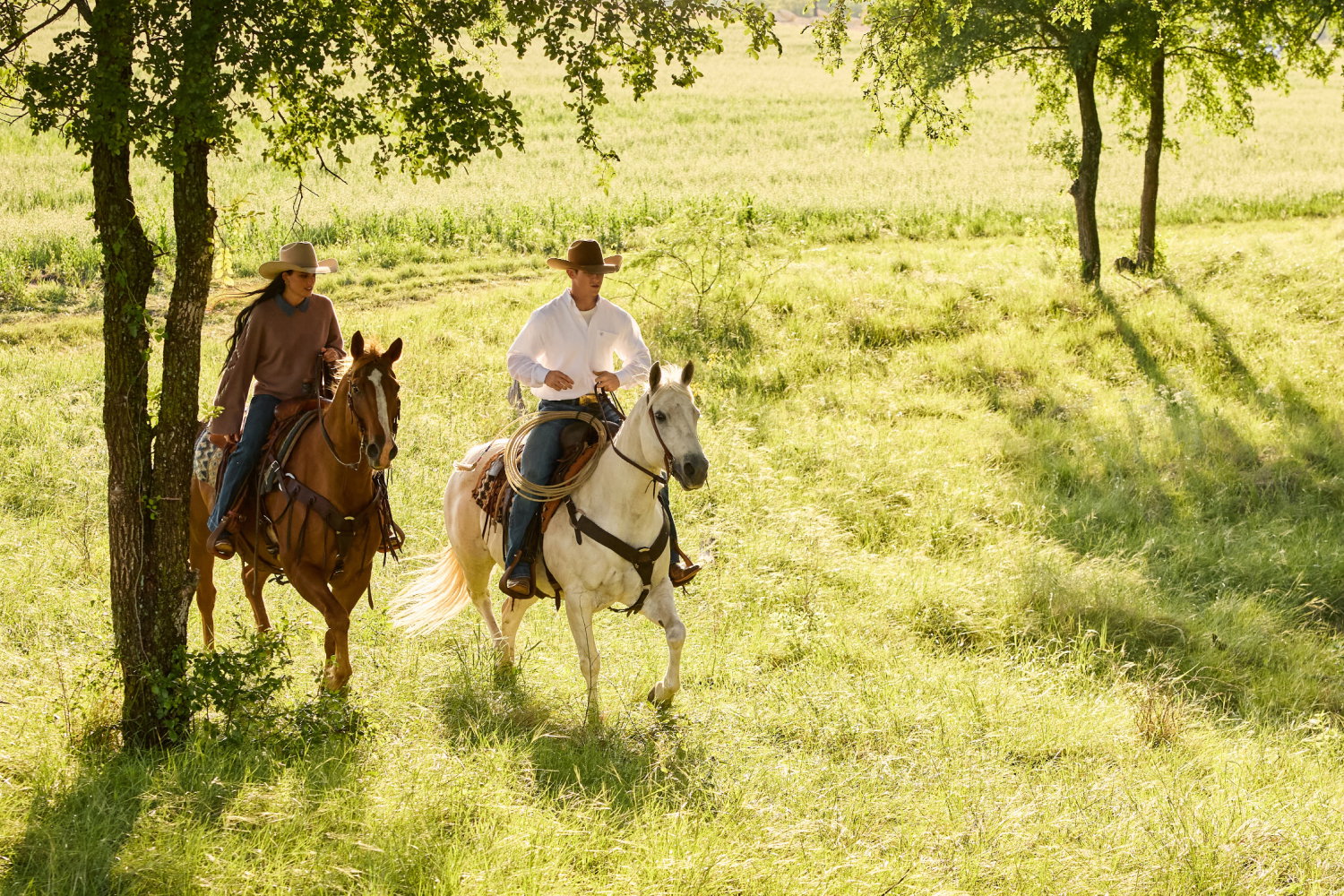 Man and women riding horses.