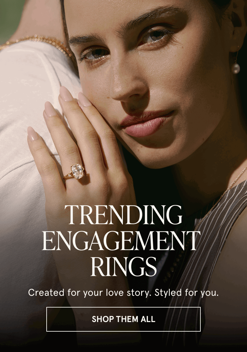 Model with oval-cut diamond ring. Trending engagement rings. Click here to shop them all